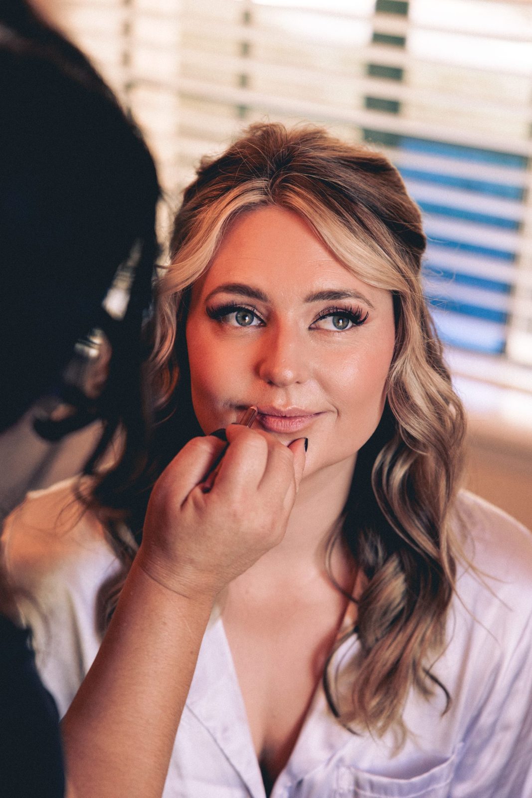 Bride laughing with glowing skin and glossy lip